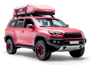 A vibrant red off-road SUV with a rooftop tent, rugged tires, and black accents, ready for adventure and exploration.